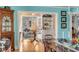 Stylish dining room with a view into the adjacent living room, featuring an antique hutch and aqua walls at 14 Guerard Rd, Charleston, SC 29407