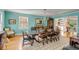Elegant dining room with turquoise walls, chandelier, large windows, and seating for ten at 14 Guerard Rd, Charleston, SC 29407