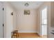 Entryway with coat rack, wooden bench and view into kitchen area, providing a welcoming and functional space at 14 Guerard Rd, Charleston, SC 29407