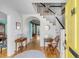 Inviting foyer with hardwood floors, staircase, yellow front door, and views of the home's interior at 14 Guerard Rd, Charleston, SC 29407