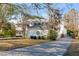 Charming two-story home with a well-manicured lawn, mature trees, and a circular window at 14 Guerard Rd, Charleston, SC 29407