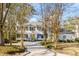 Charming two-story home with a welcoming entrance, a well-manicured lawn, and mature trees at 14 Guerard Rd, Charleston, SC 29407