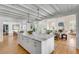 Open concept kitchen featuring a marble island, custom cabinets, stainless appliances, and hardwood floors at 14 Guerard Rd, Charleston, SC 29407