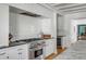Modern kitchen with white cabinets, a stylish Wolf range, and stainless steel appliances at 14 Guerard Rd, Charleston, SC 29407