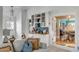 Stylish living space with a built-in wet bar, herringbone floors, and access to other rooms through open doorways at 14 Guerard Rd, Charleston, SC 29407