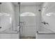 Modern shower with glass door, subway tile, marble features, and a unique circular window at 14 Guerard Rd, Charleston, SC 29407