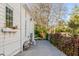 A well-maintained gravel side yard featuring mature plants, providing a serene and private outdoor space at 14 Guerard Rd, Charleston, SC 29407