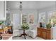 Bright sunroom featuring herringbone floors, large windows with lots of natural light, and a cozy seating area at 14 Guerard Rd, Charleston, SC 29407