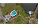 Aerial view of a community pool, clubhouse, lake, and boat house within well-manicured lawns and landscape at 149 Calm Water Way, Summerville, SC 29486