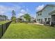 Large backyard features a stone patio with seating, a grill, and a lush lawn at 149 Calm Water Way, Summerville, SC 29486