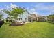 Expansive backyard featuring a patio, fire pit, screened porch, and lush green lawn at 149 Calm Water Way, Summerville, SC 29486