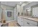 Bathroom featuring double sinks, granite countertop, and a glass-enclosed shower at 149 Calm Water Way, Summerville, SC 29486