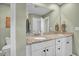 Bathroom with double vanity, granite countertop, white cabinets, and decorative mirror at 149 Calm Water Way, Summerville, SC 29486