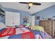 Cozy bedroom showcasing a ceiling fan, decor shelving, and a comfortable sleeping area at 149 Calm Water Way, Summerville, SC 29486