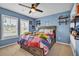 Charming bedroom with a ceiling fan, vibrant bedding, and natural light streaming through the windows at 149 Calm Water Way, Summerville, SC 29486