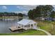 View of the community boat house and dock on a lake in a wooded area among neighborhood homes at 149 Calm Water Way, Summerville, SC 29486