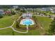 Aerial view of the beautiful community pool and clubhouse with lounge chairs in a landscaped setting among neighborhood homes at 149 Calm Water Way, Summerville, SC 29486