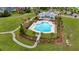 Aerial view of community pool and clubhouse with landscaped grounds and lounging, in a peaceful neighborhood setting at 149 Calm Water Way, Summerville, SC 29486