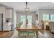 Elegant dining room featuring a large wooden table, seating for ten, and ample natural light at 149 Calm Water Way, Summerville, SC 29486