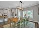 Bright and airy dining room featuring a long table with seating and modern light fixture at 149 Calm Water Way, Summerville, SC 29486