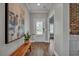 Inviting entryway features hardwood floors, neutral paint, and a stylish wooden bench and artwork at 149 Calm Water Way, Summerville, SC 29486