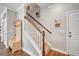 Inviting foyer with hardwood floors, staircase, and a charming coat rack at 149 Calm Water Way, Summerville, SC 29486
