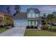 Charming two-story home with a two-car garage, well-kept lawn, and inviting front porch at 149 Calm Water Way, Summerville, SC 29486