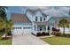 Inviting two-story home featuring a two-car garage, manicured lawn, and covered front porch at 149 Calm Water Way, Summerville, SC 29486