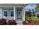 Close-up of the home's entry with a charming porch and well-kept landscaping at 149 Calm Water Way, Summerville, SC 29486