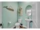 Charming half bath with a pedestal sink, round mirror, and stylish aqua-colored walls at 149 Calm Water Way, Summerville, SC 29486