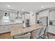 A spacious kitchen featuring white cabinets, stainless appliances, a large center island, and granite countertops at 149 Calm Water Way, Summerville, SC 29486