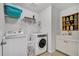 Convenient laundry room with modern washer, dryer, and a utility sink with white cabinets at 149 Calm Water Way, Summerville, SC 29486