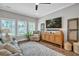 Cozy living room features a comfortable armchair and a large television with natural light at 149 Calm Water Way, Summerville, SC 29486