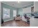Bright office space includes hardwood floors, built-in shelving, large windows, and a comfortable sitting area at 149 Calm Water Way, Summerville, SC 29486