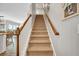 Carpeted staircase with wooden handrail leading to the upper level of the home at 149 Calm Water Way, Summerville, SC 29486