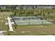 A full shot of several fenced tennis courts on a sunny day with trees surrounding the area at 149 Calm Water Way, Summerville, SC 29486