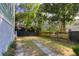 Large, fenced backyard with green grass and stepping stones, perfect for outdoor activities and relaxation at 17 Trumbo St, Charleston, SC 29401