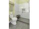 Modern bathroom featuring a glass-enclosed shower, gray floor tiles, and a classic white toilet at 17 Trumbo St, Charleston, SC 29401