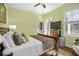 Bright bedroom with a view to the outdoor balcony, complete with wooden floors and a ceiling fan at 17 Trumbo St, Charleston, SC 29401