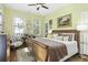 Comfortable bedroom with yellow walls, a ceiling fan, and a large window with natural light at 17 Trumbo St, Charleston, SC 29401