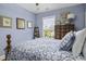Cozy bedroom featuring blue-toned walls and a bed with stylish patterned bedding and decorative pillows at 17 Trumbo St, Charleston, SC 29401