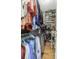Well-organized walk-in closet with ample hanging space and shelves, filled with clothes and accessories at 17 Trumbo St, Charleston, SC 29401
