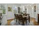 Elegant dining room with hardwood floors, chandelier, and a large window overlooking the greenery at 17 Trumbo St, Charleston, SC 29401