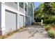 Spacious driveway leading to a gray two-car garage and fenced backyard, offering ample parking at 17 Trumbo St, Charleston, SC 29401