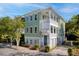 Charming two-story home with a double porch, green siding, and well-maintained landscaping at 17 Trumbo St, Charleston, SC 29401