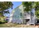 Rear view of the two-story home, showcasing the back deck, screened porch, and lush greenery at 17 Trumbo St, Charleston, SC 29401