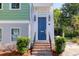 Close-up of the home's entry, showing the brick steps and a stylish blue front door with sidelights at 17 Trumbo St, Charleston, SC 29401