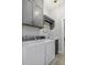Well-lit laundry room with washer, dryer, sink, and ample storage space at 17 Trumbo St, Charleston, SC 29401