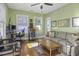 Bright green living room with tv, couch, ceiling fan, and a light hardwood floor at 17 Trumbo St, Charleston, SC 29401