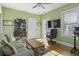 Bright green living room with tv, couch, ceiling fan, and a light hardwood floor at 17 Trumbo St, Charleston, SC 29401